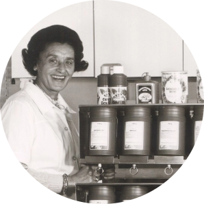 Historic black-and-white photo of Martha Laue smiling in a kitchen
